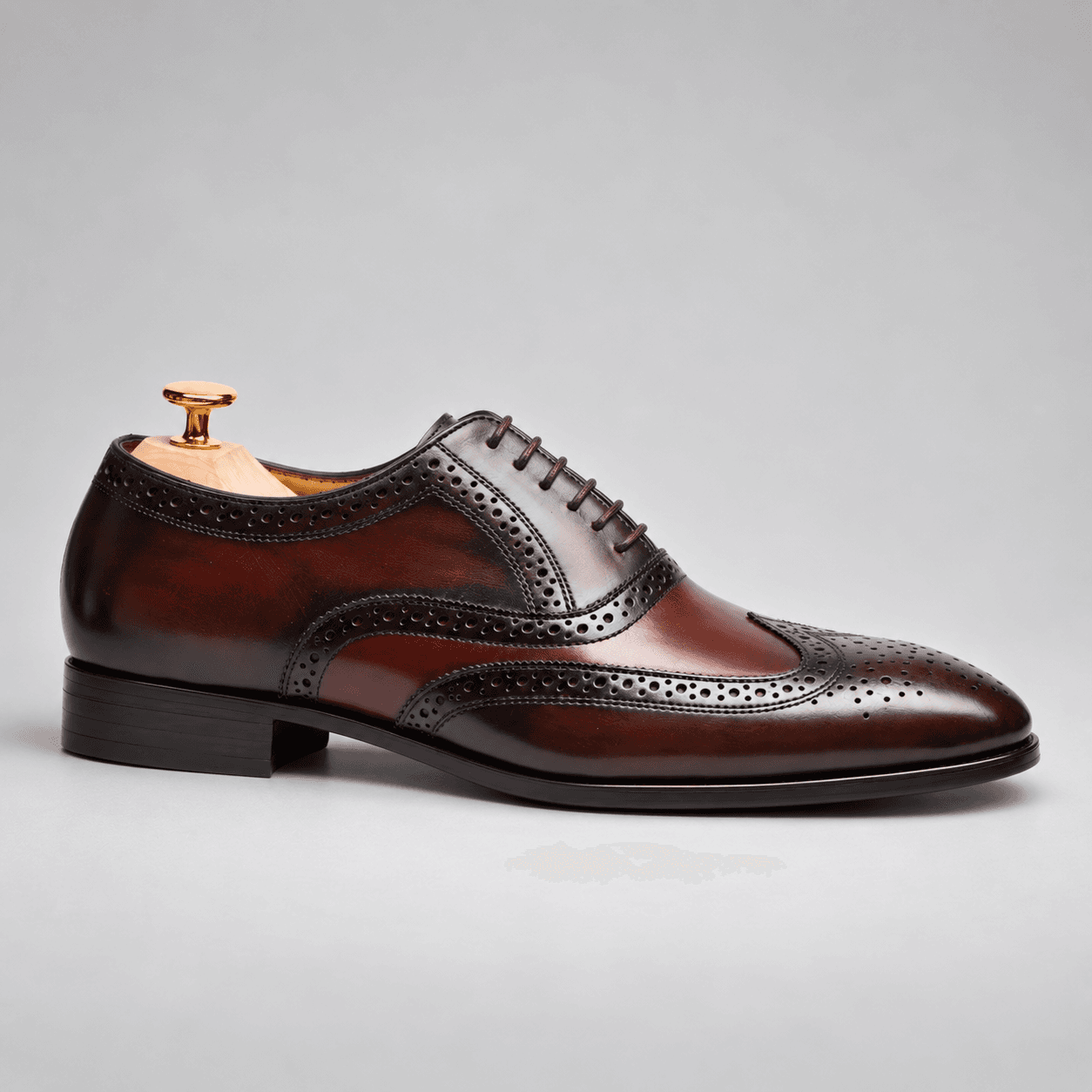 Side profile of a Gomilla burgundy leather brogue shoe
