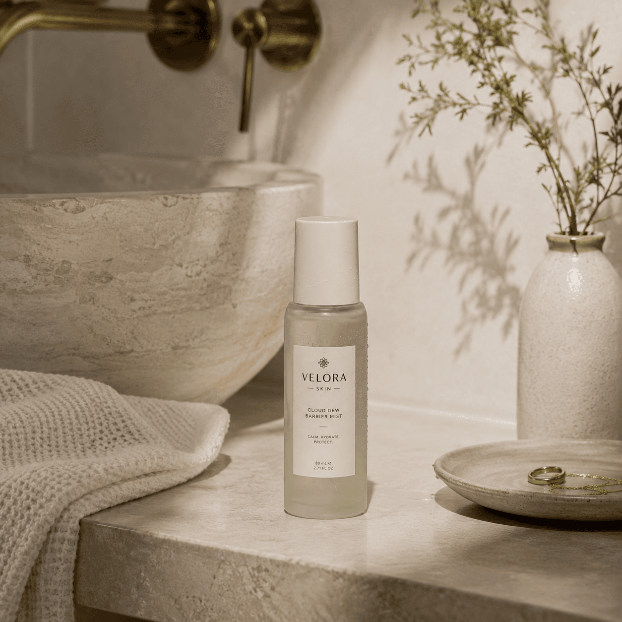 Velora Skin barrier mist styled on a marble bathroom vanity, lifestyle product photo