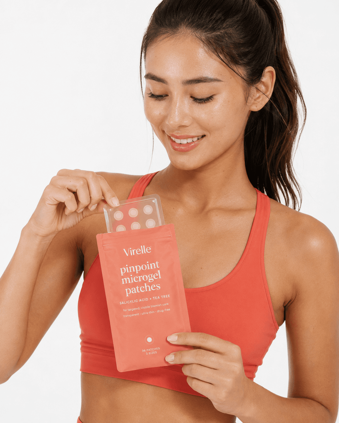 Model in activewear taking Virelle pinpoint microgel patches from the pouch, lifestyle product photo