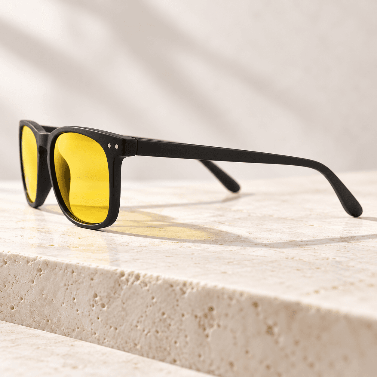 Side profile of Blue Ben glasses on a stone ledge, lifestyle product photo