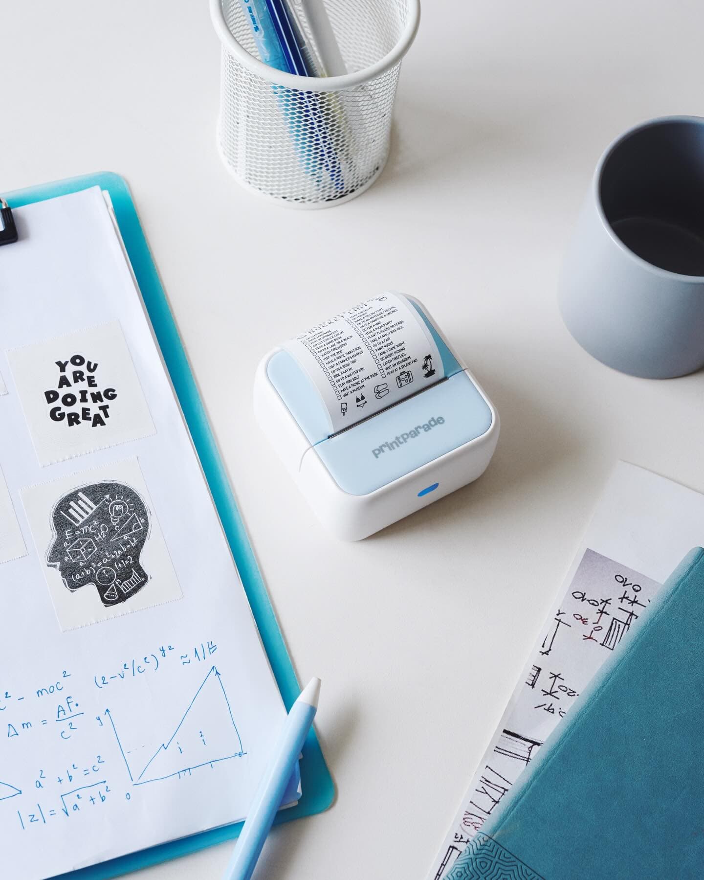 printParade thermal printer on a blue desk, styled product shot